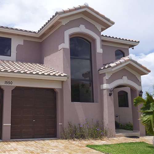 impact windows on 2-story brown home