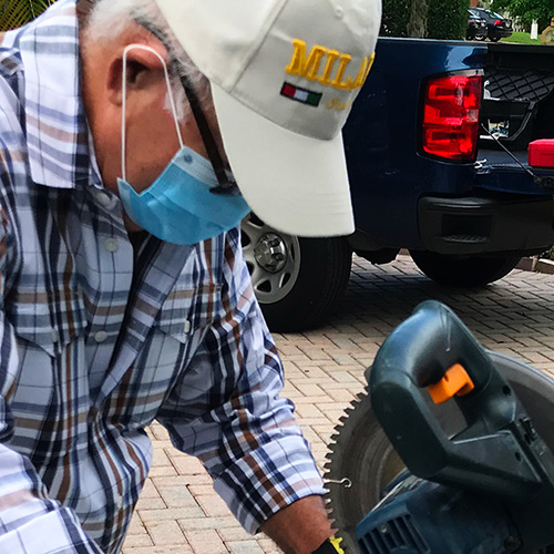 shutter installer cutting a frame to size.